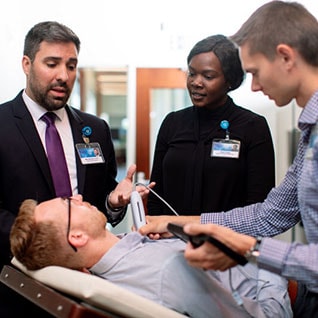 Visiting clinicians working together on a patient.